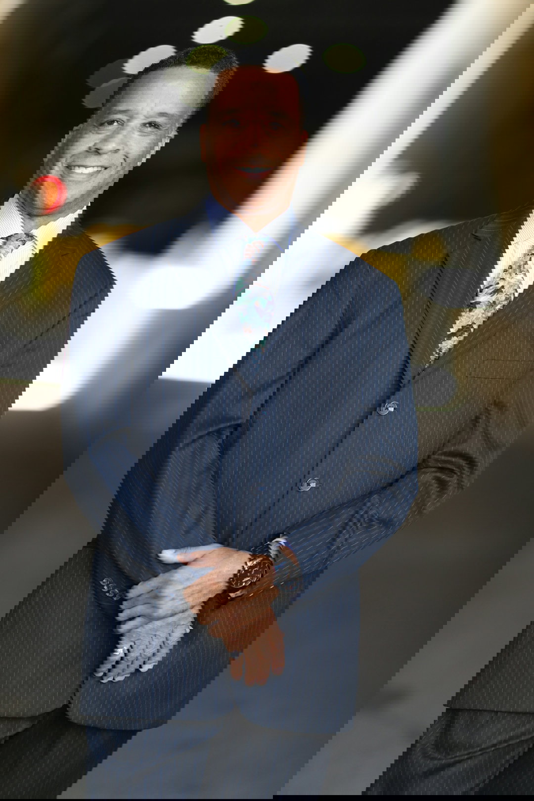 man in black suit jacket wearing black leather strap watch