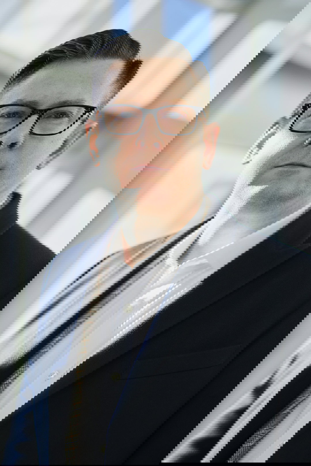 man standing beside wall